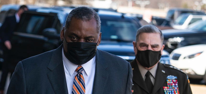 Defense Secretary Lloyd Austin III and Mark Milley, Chairman of the Joint Chiefs of Staff, enter the Pentagon on Austin's first day in his new role on January 22, 2021.