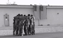 Soldiers of Special Forces, 10th Special Forces Group (Airborne) huddle together for strength as they memorialize two of their fallen brothers during a memorial held at Kunduz Airfield in Afghanistan on Nov. 7, 2016. 
