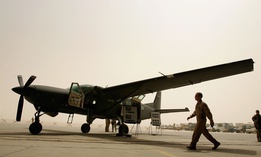 Iraqi air force members and their U.S trainers are seen near the Iraqi air force Caravan (Cessna 280) Intelligence, Surveillance and Reconnaissance (ISR) aircraft on July 30, 2008 at the New Al Muthana Air Base in Baghdad, Iraq.