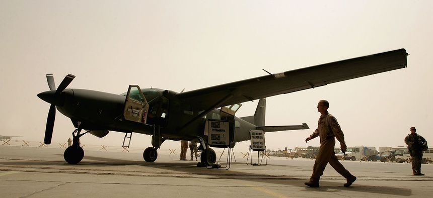 Iraqi air force members and their U.S trainers are seen near the Iraqi air force Caravan (Cessna 280) Intelligence, Surveillance and Reconnaissance (ISR) aircraft on July 30, 2008 at the New Al Muthana Air Base in Baghdad, Iraq.