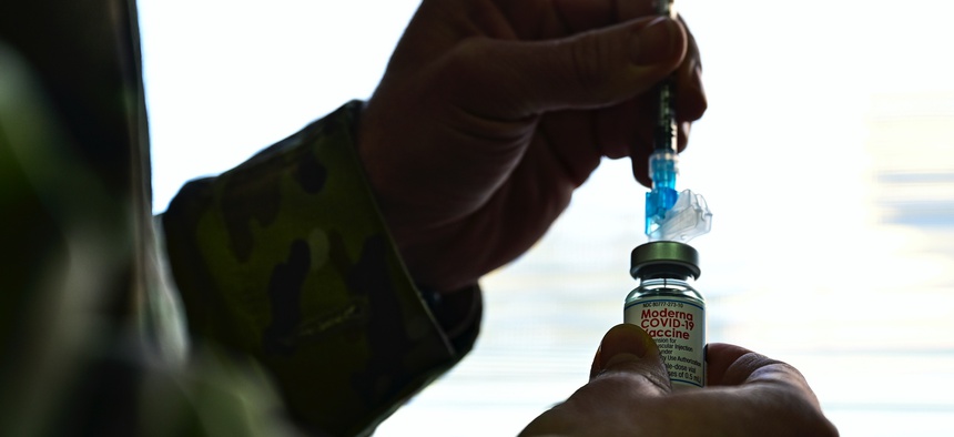 A service member prepares a COVID-19 vaccination dose on Feb. 4, 2021.