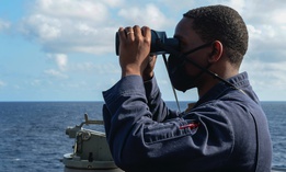 Ens. Ryan Simpson stands on the bridge wing of the guided-missile destroyer Russell while operating in the South China Sea last week.