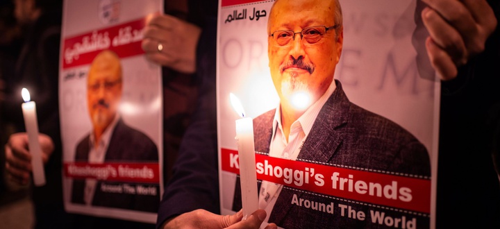 People hold posters, ... ]