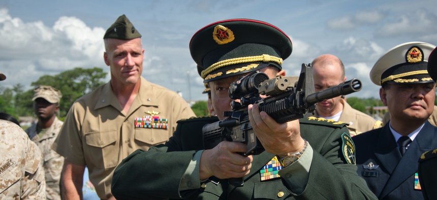 One of the general officers accompanying China's Minister of National Defense shoulders an M4 carbine during a 2012 visit to Marine Corps Base Camp Lejeune, N.C.
