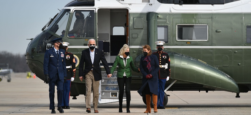 U.S. President Joe Biden and First Lady Jill Biden are greeted by Col. Stephen P. Snelson (L) and his wife, Catherine Snelson (R), as the Bidens arrive to board Air Force One at Joint Base Andrews in Maryland on February 26, 2021.