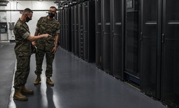 U.S. Marine Corps Maj. Gen. Robert F. Castellvi, left, the commanding general of 1st Division, speaks to Lt. Col. Koichi Takagi, about the Division Network Operations Center on Camp Pendleton, California, in 2020.