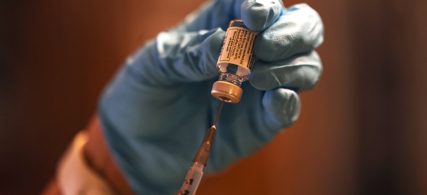 A doctor prepares a dose of the Johnson & Johnson COVID-19 vaccine.