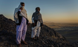 Rohullah Salhe, 35, former Taliban member and former prisoner, left, and Jumah Gul, 40, right, a Taliban commander, stand in the mountains on the outskirts of Kandahar, Afghanistan, on Monday Oct. 26, 2020.